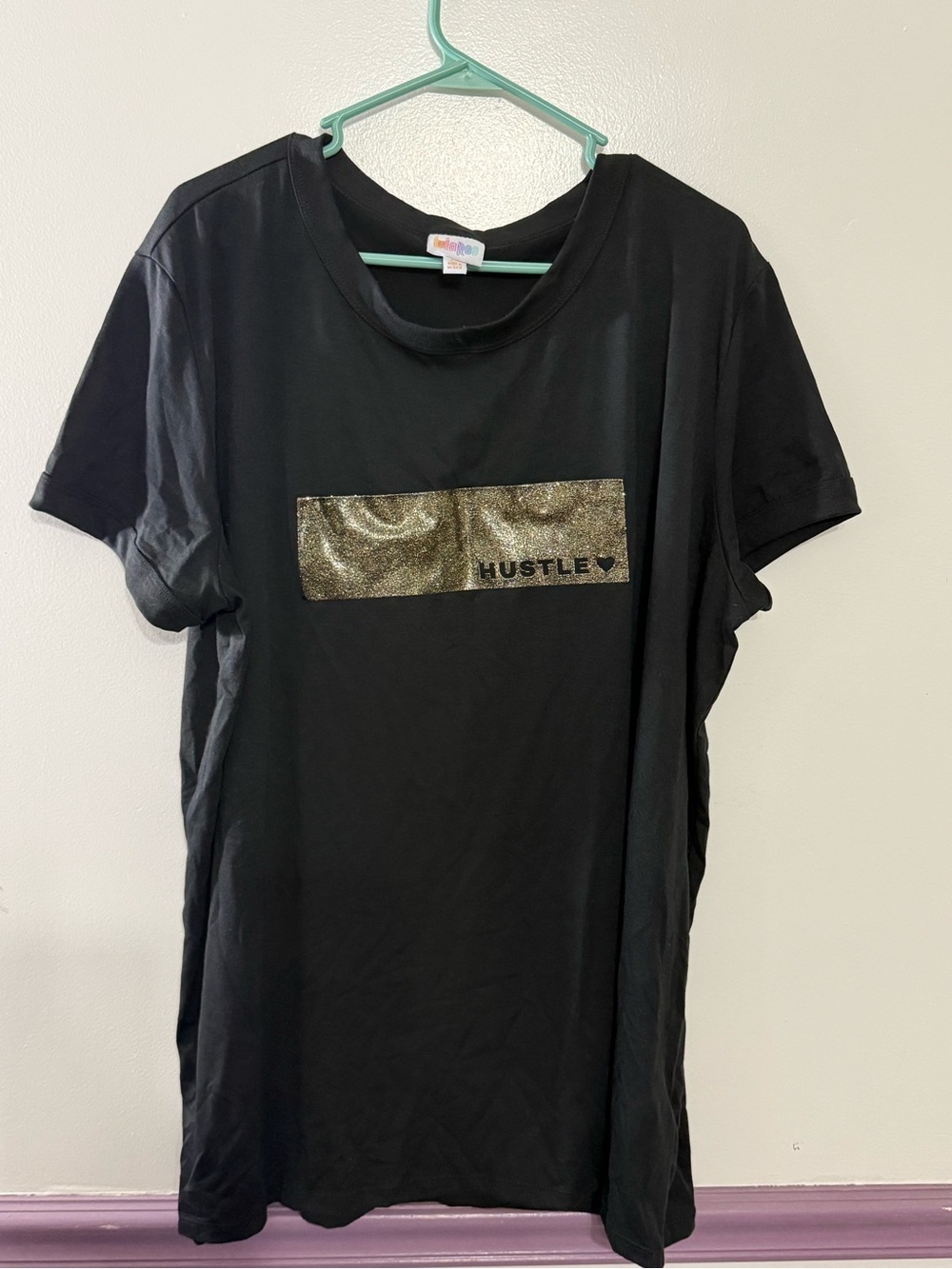 LuLaRoe Liv Tee Black Short Sleeve Tee with Gold Glitter 'HUSTLE' Panel